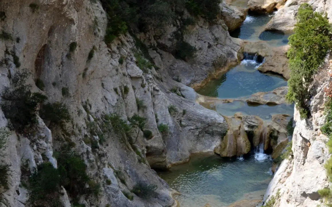 Les gorges de Galamus, un itinéraire spectaculaire avec des cascades et des bassins d'eau turquoise creusés dans la roche.